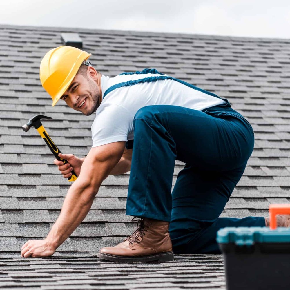 selective-focus-of-handsome-handyman-repairing-roof.jpg
